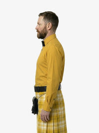 Man wearing a yellow shirt and plaid kilt on a white background