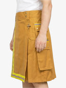 Yellow skirt with reflective stripes worn by a person on a white background