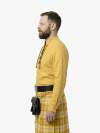 Man wearing a yellow shirt and plaid skirt with a black bag on a white background