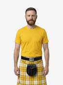 Man wearing a yellow shirt and plaid kilt on a white background
