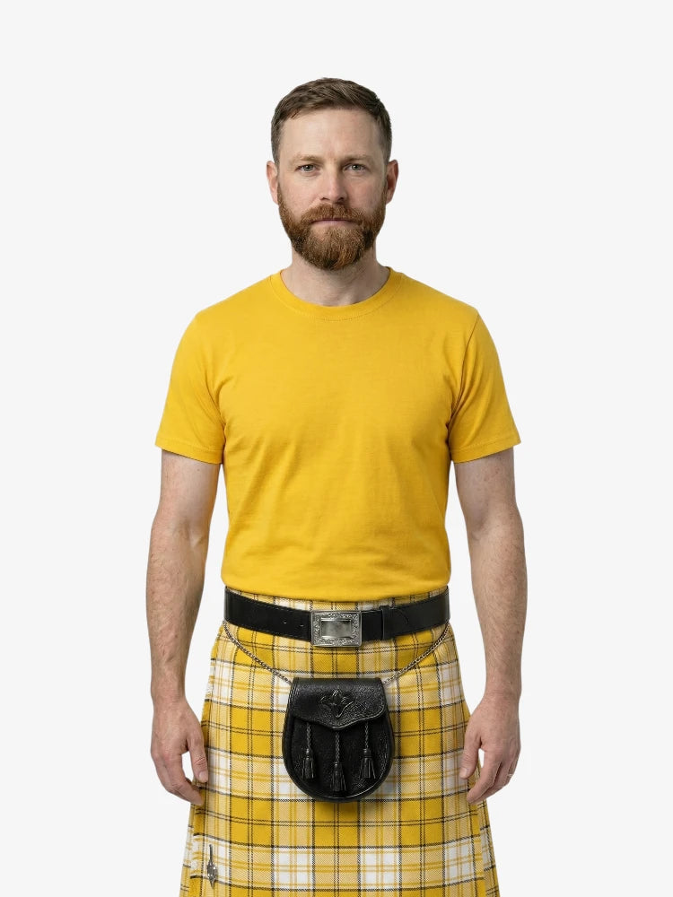 Man wearing a yellow shirt and plaid kilt on a white background