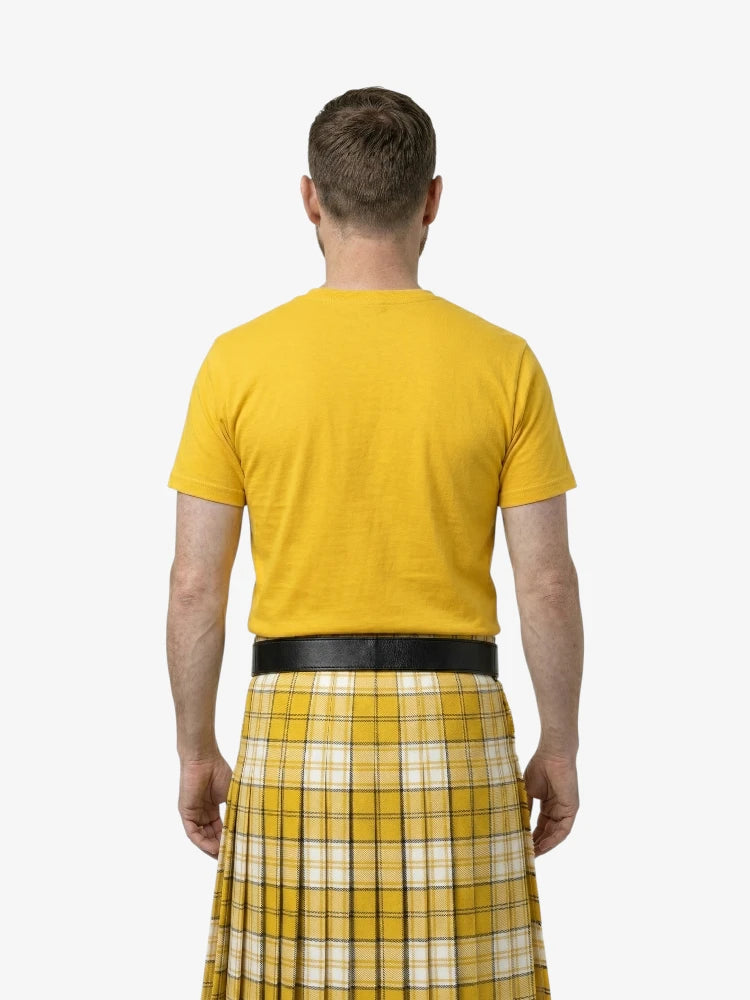 Man wearing a yellow t-shirt and plaid kilt on a white background