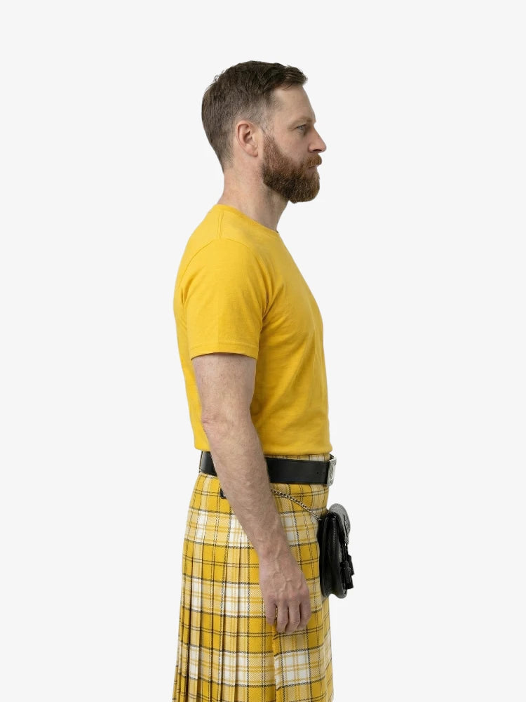 Man wearing a yellow t-shirt and plaid skirt on a white background